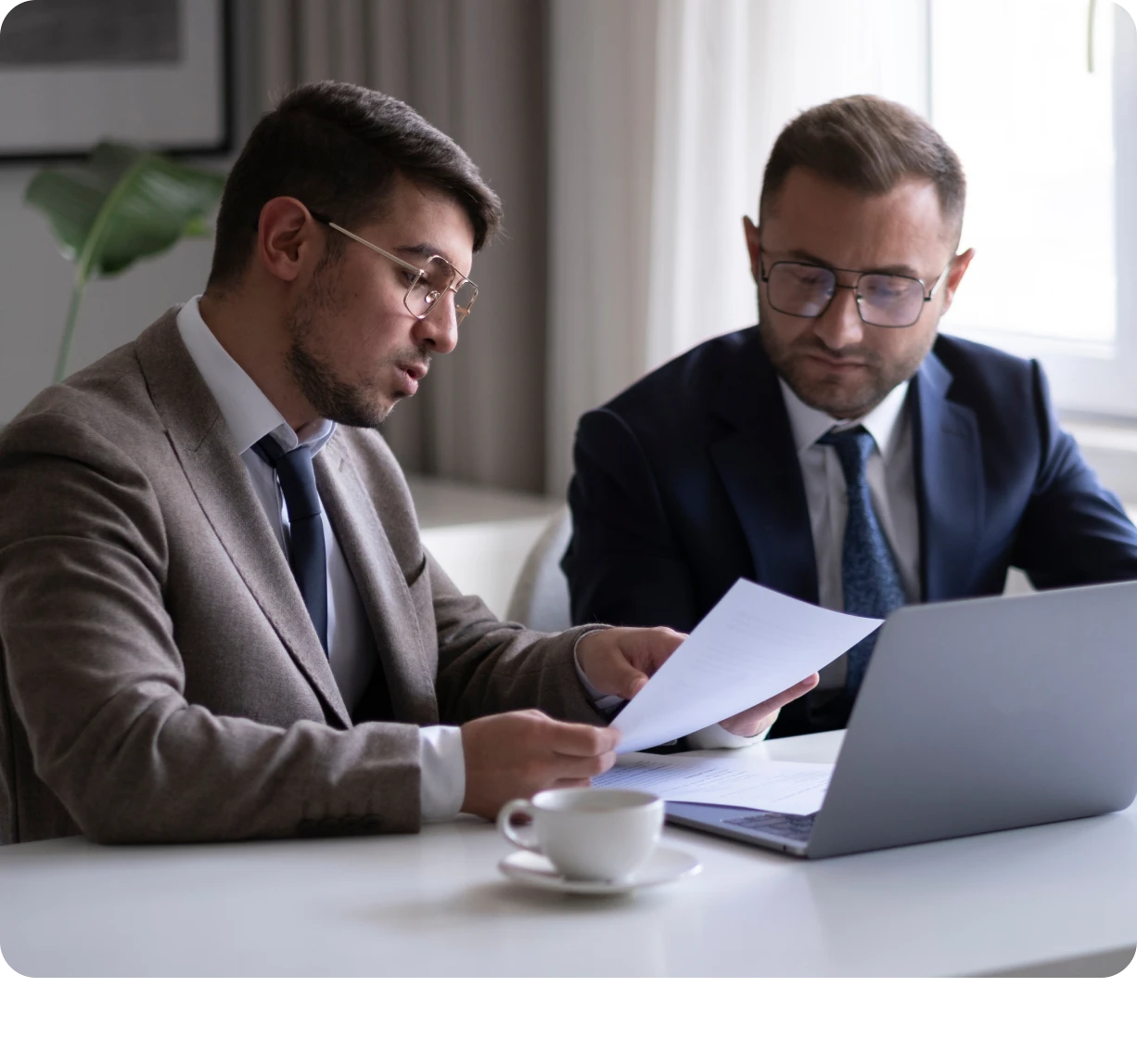 Professionals analyzing paperwork in office setting